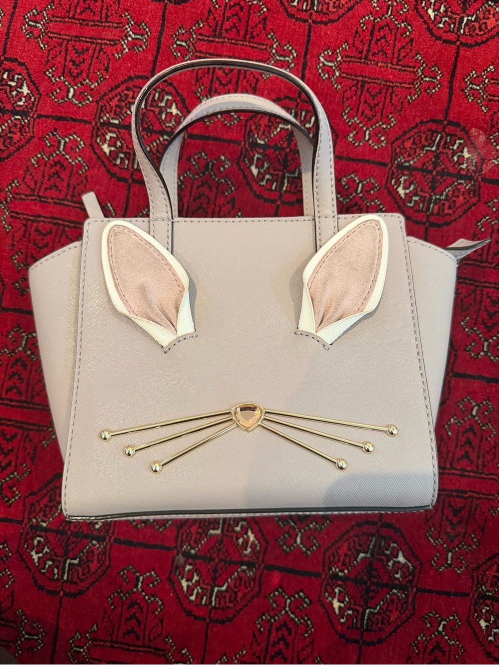 kate spade cream mini tote with gold-tone bunny whisker detail